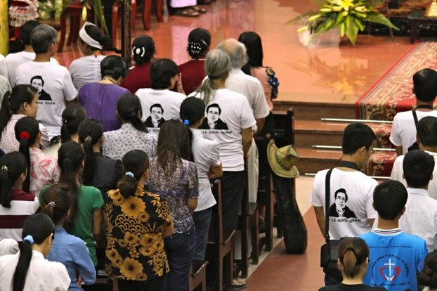 Supporters wear t-shirts bearing a portrait of Le Quoc Quan during a mass held for him at a Catholic church in Hanoi on July 7, 2013. (Photo: AFP)
