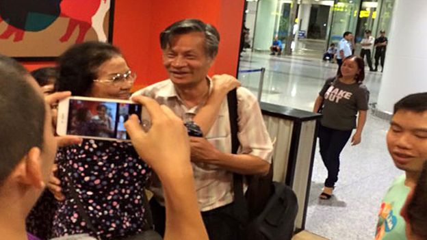 Nguyen Quang A is greeted after his release from detention at airport in Hanoi, Sept. 2, 2015.