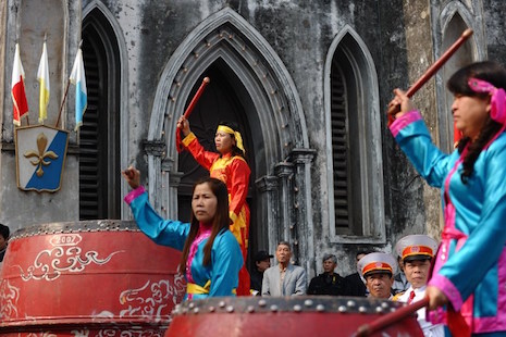 Catholics beat drums during a welcoming ceremony at a cathedral in Hanoi in January. (Photo by Hoang Dinh Nam/AFP)