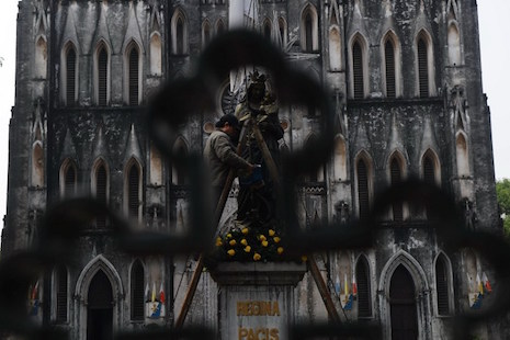 A worker polishes a statue in front of Hanoi's cathedral in January 2015. Catholicism is one of Vietnam's largest religions, but the government takes a strong stand against people who are politically active. (Photo by Hoang Dinh Nam/AFP)