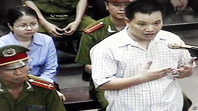 FILE - Nguyen Van Dai, right, testifies in this May 2013 file photo, originally taken from TV footage. The well-known Vietnamese human rights lawyer was arrested Wednesday on anti-state "propaganda" charges.