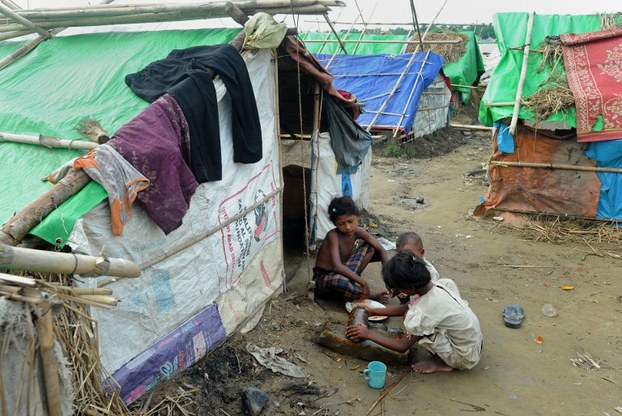 Rohingya children prepare a meal at a camp for internally displaced people on the outskirts of Sittwe, in a file photo.