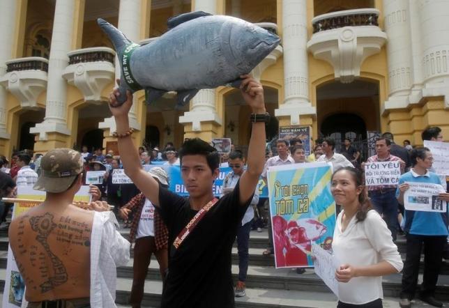 Demonstrators, holding signs of environmental-friendly messages, say they are demanding cleaner waters in the central regions after mass fish deaths in recent weeks, in Hanoi, Vietnam May 1, 2016.