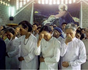 File image shows vietnamese Catholic women making a sign of the cross during a mass on Holy Thursday in the central highland city of Buon Ma Thuot.